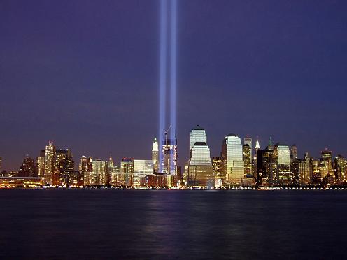 A picture of the World Trade Center location after the attacks, on an anniversary, with beams of light placed where the towers stood.