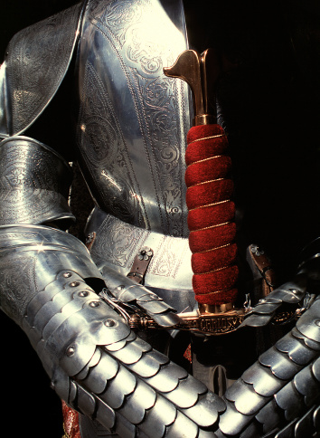 A shiny suit of armor holding a sword represents, both, the archaic ideas about honor, and also the idea of honor being one's strength in character.